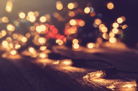 christmas light decor on wood background , color filter vintage toneの写真素材