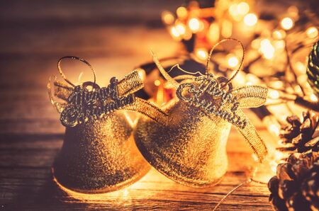 Christmas background with Christmas decoration shine bells with ribbon bows on a wooden table background with copy space, Grunge style,の写真素材