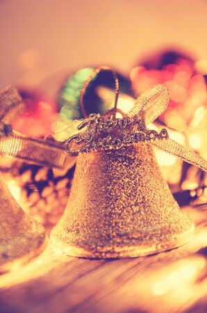 Christmas background with Christmas decoration shine bells with ribbon bows on a wooden table background with copy space, Grunge style,の写真素材