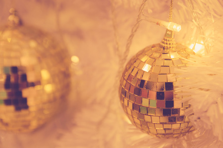 christmas ornaments gold ball and light bulb on christmas treeの写真素材
