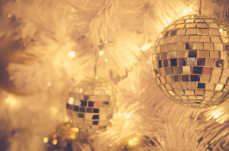 christmas ornaments gold ball and light bulb on christmas treeの写真素材