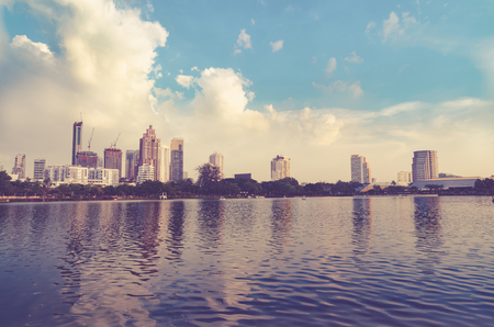 Landscape building modern business district of bangkok at twilgiht sky, beautiful water reflection.の写真素材