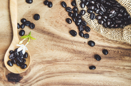 Studio Shot of Coffee Beans in a Bag with wooden table: vintage processの写真素材