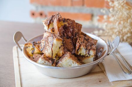 dessert - chocolat powder and bread on wood table in cafeの写真素材