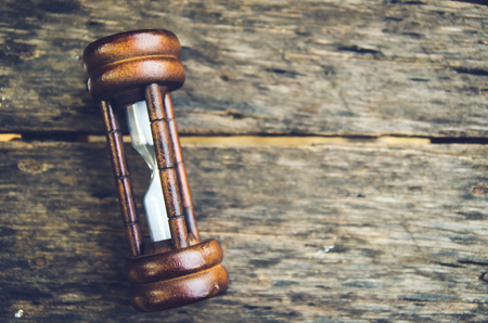Hourglass time passing concept for business deadline, urgency and running out of timeの写真素材