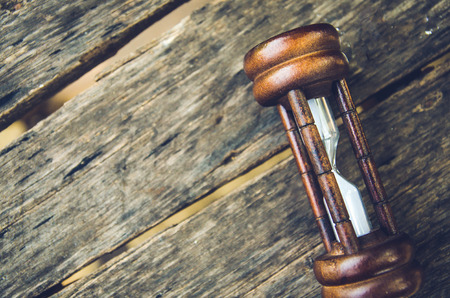 Hourglass time passing concept for business deadline, urgency and running out of timeの写真素材