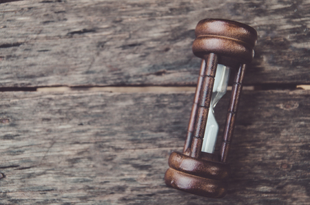 Hourglass time passing concept for business deadline, urgency and running out of timeの写真素材