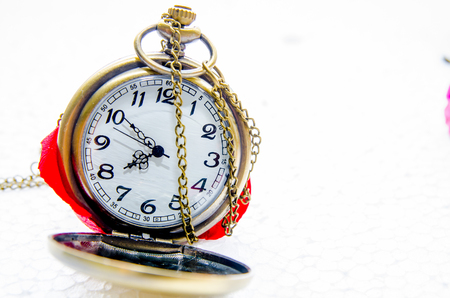 Red Rose and a pocket watch on a napkin embroidered with a crossの写真素材