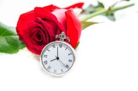 Red Rose and a pocket watch on a napkin embroidered with a crossの写真素材