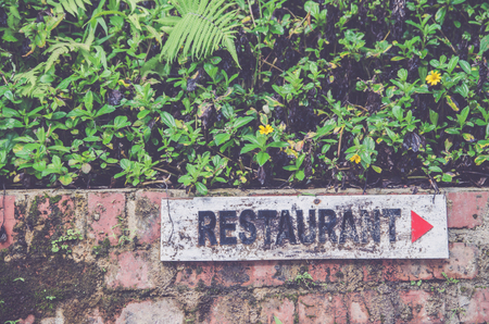 restaurant sign arrow on brickwallの写真素材