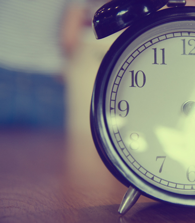 Retro alarm clock  on wood tableの写真素材