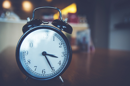 Retro alarm clock  on wood tableの写真素材