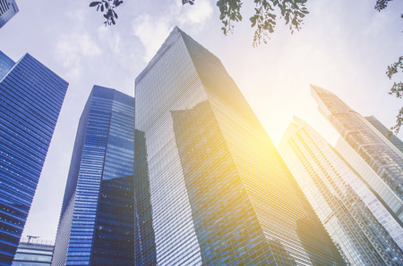 Modern business skyscrapers, high-rise buildings, architecture raising to the sky, sun. Concepts of financial, economics, future etc.の写真素材
