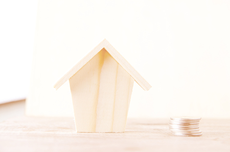 Money coins stack growing with wood  house on wood background. Business growth investment and financial concept ideas.Real estate investment. House and coins on table.Save money with stack coin.の写真素材