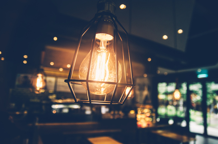 Beautiful retro luxury light lamp decor glowing  in coffee shop の写真素材