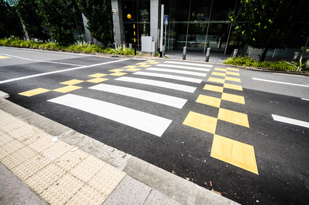 Crosswalk and pedestrian at modern city zebra crossing street in rainy day. Blur abstract.の写真素材