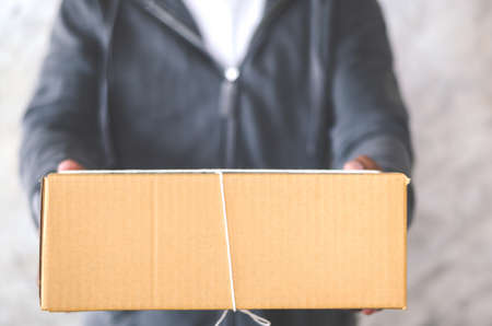 Delivery man carrying a parcel boxの写真素材
