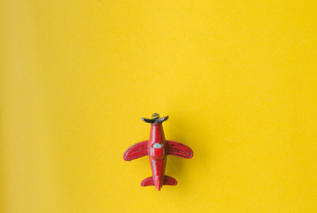 Airplan toy on yellow paper background retro image