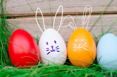 Easter eggs cute bunny. Funny happy in easter day on wood background の写真素材