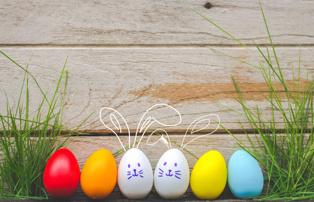 Easter eggs cute bunny. Funny happy in easter day on wood background の写真素材