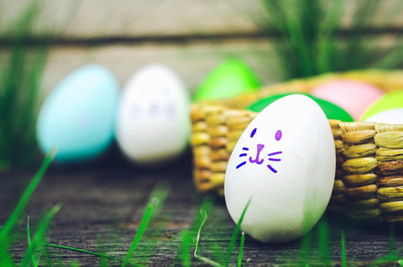 Easter eggs cute bunny. Funny happy in easter day on wood background の写真素材