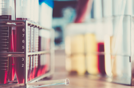 A pipette dropping sample into a test tube,abstract science backgroundの写真素材