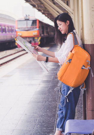 young women hold map on hand in train stationのeditorial素材