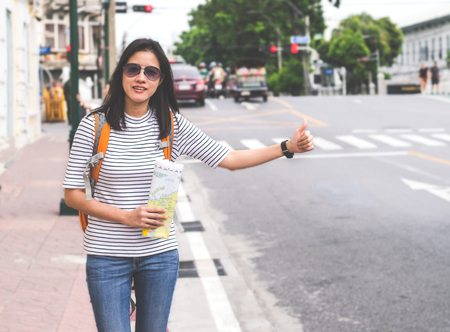 smart women treveller in bangkok calling sign on roadの写真素材