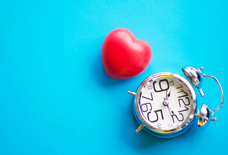 Alarm clock on a pink background, symbolically ringing the hearts. The concept of the time of love, the time of date, the wedding, the day of St. Valentine and heallty or health conceptの写真素材