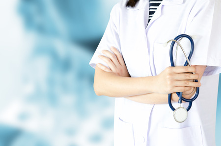 Medical physician doctor woman over blue clinic background.の写真素材