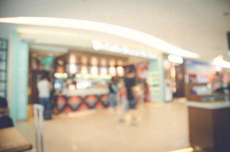Blurred background made with Vintage Tones,Coffee shop blur background with bokeh and working man in cafeの写真素材