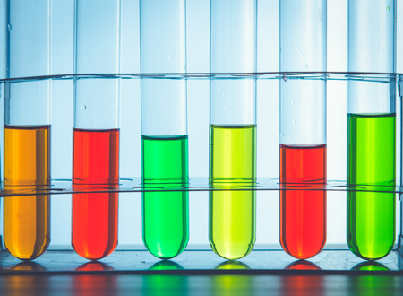 A pipette dropping sample into a test tube,abstract science backgroundの写真素材