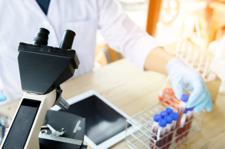 Close-up shot of microscope with metal lens at laboratory. Scientific and healthcare research background.の写真素材