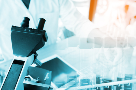 Close-up shot of microscope with metal lens at laboratory. Scientific and healthcare research background.の写真素材