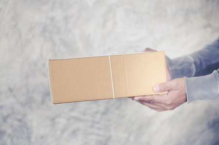 delivery man carrying a parcel boxの写真素材