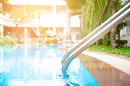 Grab bars ladder in the blue swimming poolの写真素材