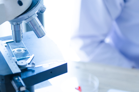 Close-up shot of microscope with metal lens at laboratory. Scientific and healthcare research background.の写真素材