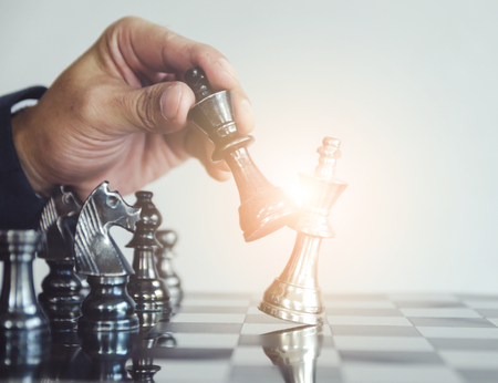 Detail of a hand making the first move in a chess game, moving the pawn one field forward. Selective focusの写真素材