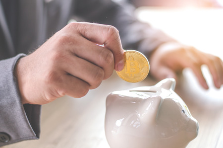Gold bitcoin money is power no matter . A coin in business man . Cryptocurrency digital currency concept. BlockChain and Saving Conceptの写真素材
