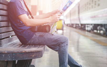 Young man traveler with map on street building backgroundの写真素材