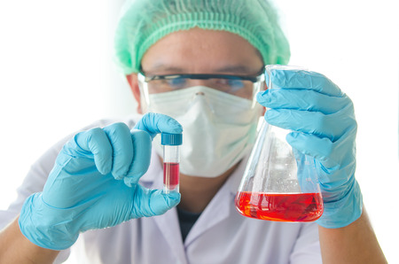 Young scientist looking through a microscope in a laboratory. Young scientist doing some research.の写真素材