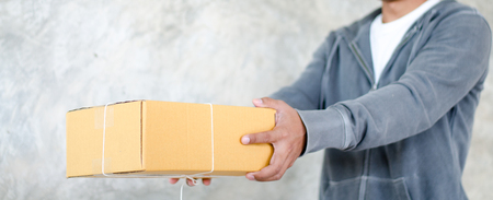 delivery man carrying a parcel boxの写真素材