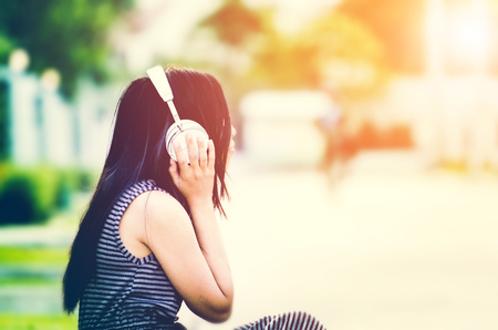 women ware white headset enjoy with musicの写真素材