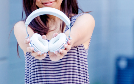 Happy teen hold headset and little smileの写真素材