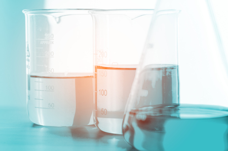 A pipette dropping sample into a test tube,abstract science backgroundの写真素材