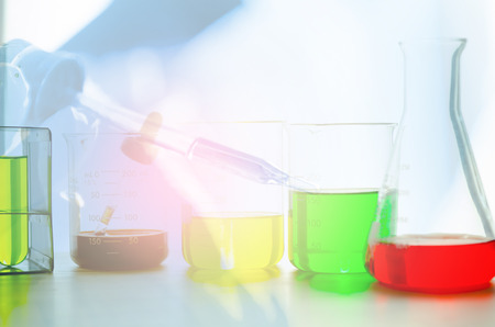 A pipette dropping sample into a test tube,abstract science backgroundの写真素材