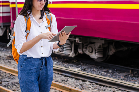 Asian woman passenger using the technology tablet in the trainの写真素材