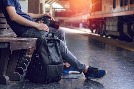 man bag pack tourist with camera in railway stationの写真素材