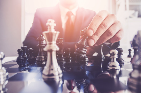 Detail of a hand making the first move in a chess game, moving the pawn one field forward. Selective focusの写真素材