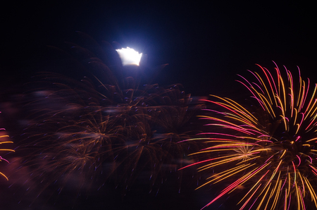 colorful fireworks on the black sky background over-waterの写真素材
